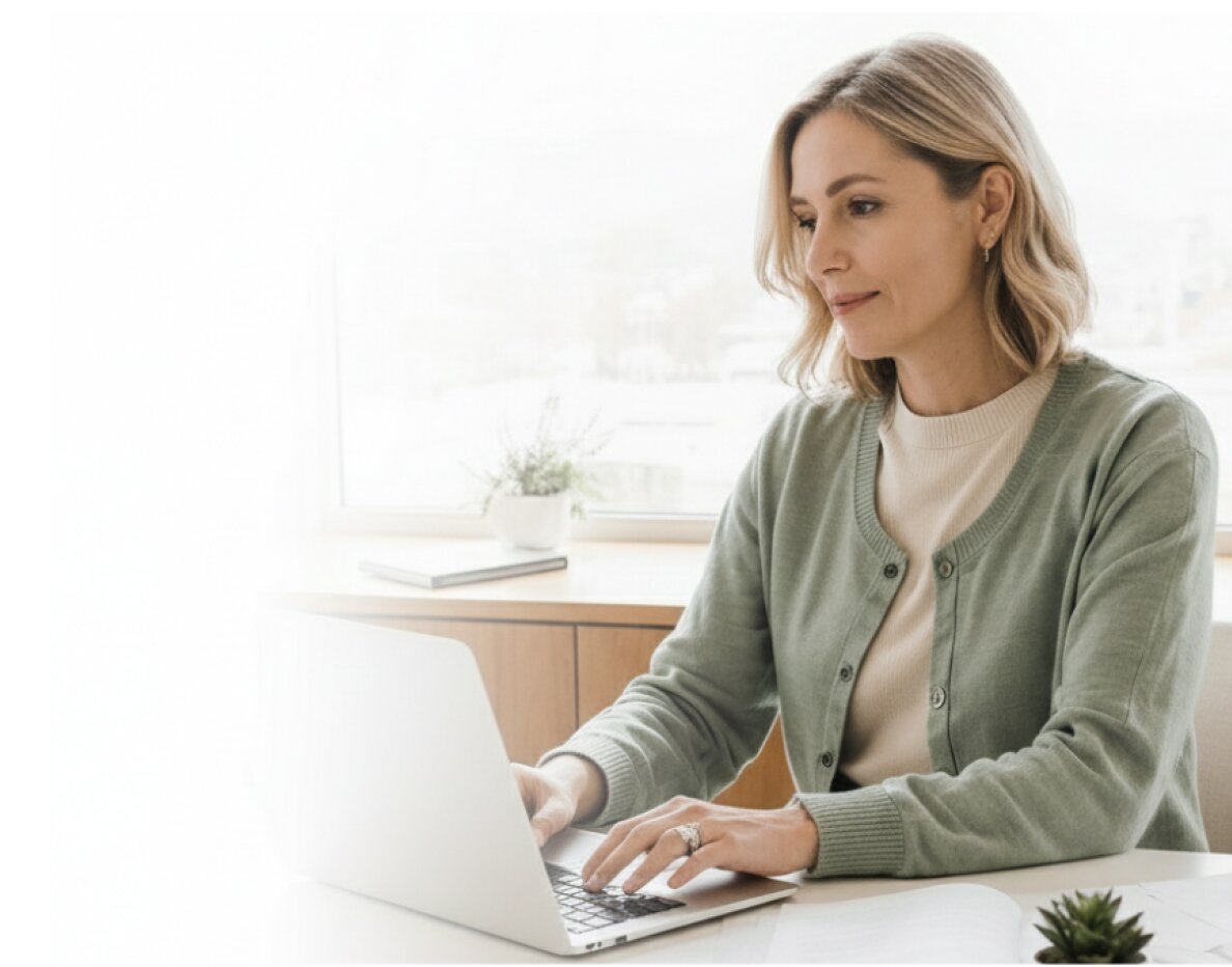 An analyst reviewing claims data on a laptop in a bright office